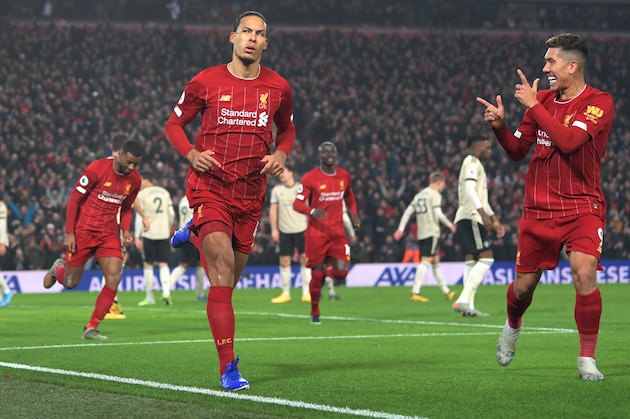 LIVERPOOL, ENGLAND - JANUARY 19: Virgil van Dijk of Liverpool celebrates with Roberto Firmino after scoring his team's first goa during the Premier League match between Liverpool FC and Manchester United at Anfield on January 19, 2020 in Liverpool, United Kingdom. (Photo by Michael Regan/Getty Images)