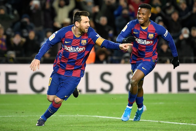 Barcelona's Argentine forward Lionel Messi (L) celebrates after scoring the opening goal during the Spanish league football match between FC Barcelona and Granada FC at the Camp Nou stadium in Barcelona on January 19, 2020. (Photo by LLUIS GENE / AFP) (Photo by LLUIS GENE/AFP via Getty Images)