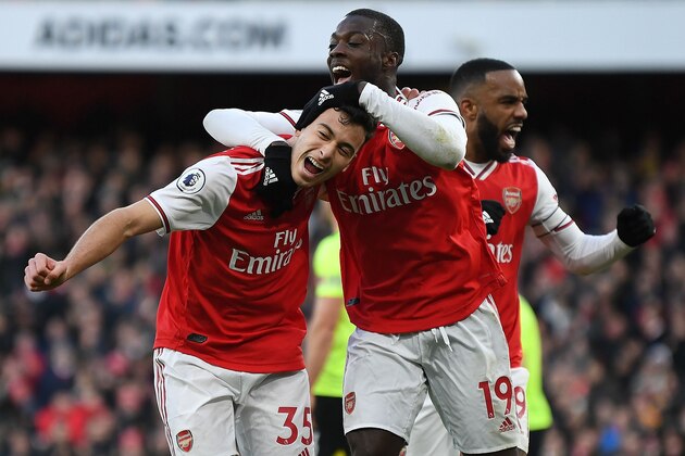 Arsenal's Brazilian striker Gabriel Martinelli (L) celebrates scoring the opening goal with Arsenal's French-born Ivorian midfielder Nicolas Pepe (C) and Arsenal's French striker Alexandre Lacazette during the English Premier League football match between Arsenal and Sheffield United at the Emirates Stadium in London on January 18, 2020. (Photo by DANIEL LEAL-OLIVAS / AFP) / RESTRICTED TO EDITORIAL USE. No use with unauthorized audio, video, data, fixture lists, club/league logos or 'live' services. Online in-match use limited to 120 images. An additional 40 images may be used in extra time. No video emulation. Social media in-match use limited to 120 images. An additional 40 images may be used in extra time. No use in betting publications, games or single club/league/player publications. /  (Photo by DANIEL LEAL-OLIVAS/AFP via Getty Images)