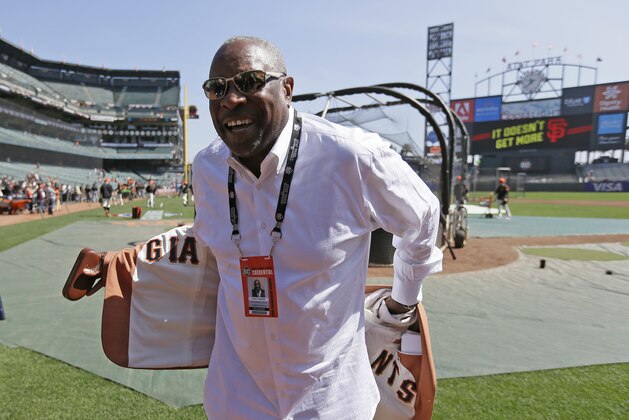 FILE -  In this April 3, 2018, file photo, former manager Dusty Baker shows off the lining of his sport coat before the start of an opening day baseball game between the San Francisco Giants and the Seattle Mariners in San Francisco. Baker lost his job with Washington after last season, when he guided the Nationals to a second straight NL East title. It has been a blessing of sorts. Baker never forgets to remind himself of his good fortune, even during the down times in his big league baseball career spanning a half-century. Sure, he still wants to manage and go out on his own terms when the time comes. (AP Photo/Eric Risberg, File)