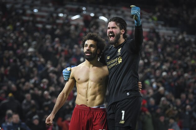 LIVERPOOL, ENGLAND - JANUARY 19: Mohamed Salah of Liverpool celebrates his goal to make it 2-0 with Alisson Becker during the Premier League match between Liverpool FC and Manchester United at Anfield on January 19, 2020 in Liverpool, United Kingdom. (Photo by Michael Regan/Getty Images) LIVERPOOL, ENGLAND - JANUARY 19: Mohamed Salah of Liverpool celebrates his goal to make it 2-0 with Alisson Becker during the Premier League match between Liverpool FC and Manchester United at Anfield on January 19, 2020 in Liverpool, United Kingdom. (Photo by Michael Regan/Getty Images)