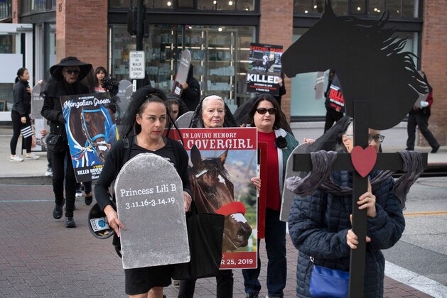 Members of the group Horseracing Wrongs and their supporters hold a