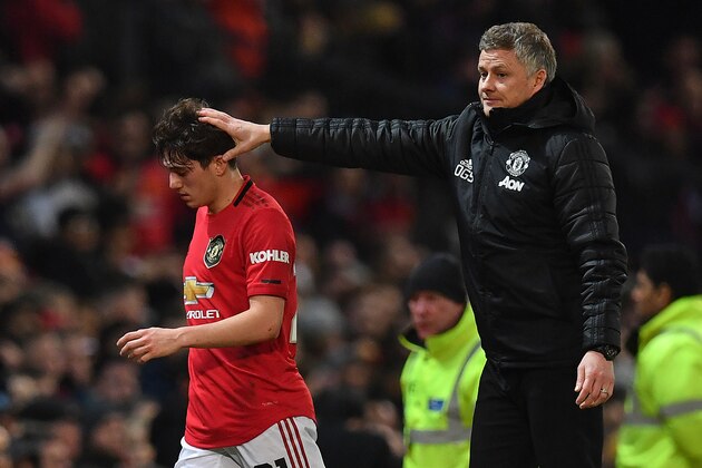 Manchester United's Norwegian manager Ole Gunnar Solskjaer (R) consoles Manchester United's Welsh midfielder Daniel James as he is substituted off the pitch during the English League Cup semi-final first leg football match between Manchester United and Manchester City at Old Trafford in Manchester, north west England on January 7, 2020. (Photo by Paul ELLIS / AFP) / RESTRICTED TO EDITORIAL USE. No use with unauthorized audio, video, data, fixture lists, club/league logos or 'live' services. Online in-match use limited to 75 images, no video emulation. No use in betting, games or single club/league/player publications. /  (Photo by PAUL ELLIS/AFP via Getty Images)