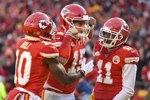 Kansas City Chiefs' Patrick Mahomes (15) celebrates with Tyreek Hill (10) and Demarcus Robinson after running for a touchdown during the first half of the NFL AFC Championship football game against the Tennessee Titans Sunday, Jan. 19, 2020, in Kansas City, MO. (AP Photo/Ed Zurga)