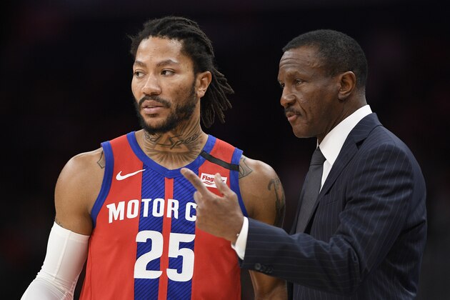 Detroit Pistons head coach Dwane Casey, right, talks with guard Derrick Rose (25) during the first half of an NBA basketball game against the Washington Wizards, Monday, Jan. 20, 2020, in Washington. (AP Photo/Nick Wass)
