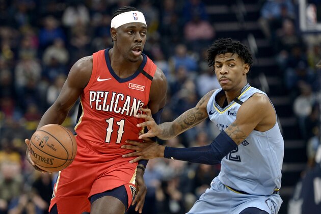 New Orleans Pelicans guard Jrue Holiday (11) handles the ball against Memphis Grizzlies guard Ja Morant in the first half of an NBA basketball game Monday, Jan. 20, 2020, in Memphis, Tenn. (AP Photo/Brandon Dill)