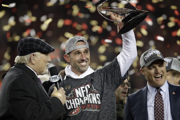 San Francisco 49ers head coach Kyle Shanahan, center, and general manager John Lynch, right, celebrate during an interview with Terry Bradshaw, left, after the NFL NFC Championship football game against the Green Bay Packers Sunday, Jan. 19, 2020, in Santa Clara, Calif. The 49ers won 37-20 to advance to Super Bowl 54 against the Kansas City Chiefs. (AP Photo/Ben Margot)