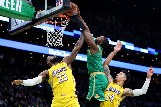 BOSTON, MASSACHUSETTS - JANUARY 20: Jaylen Brown #7 of the Boston Celtics dunks over LeBron James #23 and Danny Green #14 of the Los Angeles Lakers at TD Garden on January 20, 2020 in Boston, Massachusetts. The Celtics defeat the Lakers 139-107.  (Photo by Maddie Meyer/Getty Images)