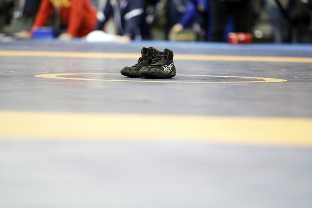 Spenser Mango's shoes sit on the center of the mat after losing to Jesse Thielke in their 59-kilogram Greco Roman match at the U.S. Olympic Wrestling Team Trials, Saturday, April 9, 2016, in Iowa City, Iowa. (AP Photo/Charlie Neibergall)
