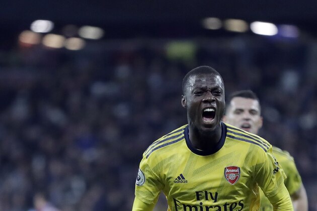 Arsenal's Nicolas Pepe celebrates after scoring his side's second goal during the English Premier League soccer match between West Ham Utd and Arsenal at the London Stadium in London, Monday, Dec. 9, 2019. (AP Photo/Kirsty Wigglesworth)