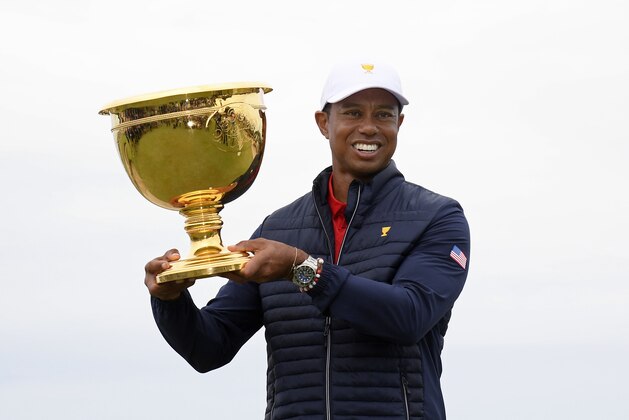 U.S. team player and captain Tiger Woods holds up the trophy after the U.S. team won the President's Cup golf tournament at Royal Melbourne Golf Club in Melbourne, Sunday, Dec. 15, 2019. The U.S. team won the tournament 16-14. (AP Photo/Andy Brownbill)