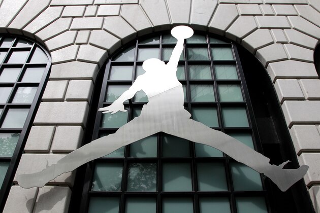 FILE - In this June 27, 2011 file photo, the Nike Air Jordan logo is shown in front of the Niketown store in downtown Portland, Ore. The way Americans are chomping Big Macs, lacing up Air Jordans and gulping peppermint mochas at Starbucks in this abysmal economy, you’d think they’re taking advantage of big holiday discounts. (AP Photo/Rick Bowmer, File) FILE - In this June 27, 2011 file photo, the Nike Air Jordan logo is shown in front of the Niketown store in downtown Portland, Ore. The way Americans are chomping Big Macs, lacing up Air Jordans and gulping peppermint mochas at Starbucks in this abysmal economy, you’d think they’re taking advantage of big holiday discounts. (AP Photo/Rick Bowmer, File)