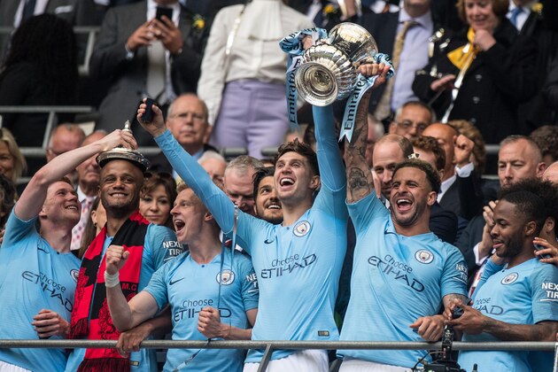 LONDON, ENGLAND - MAY 18: John Stones and Kyle Walker of Manchester City lift FA trophy during the FA Cup Final match between Manchester City and Watford at Wembley Stadium on May 18, 2019 in London, England. (Photo by Sebastian Frej/MB Media/Getty Images) LONDON, ENGLAND - MAY 18: John Stones and Kyle Walker of Manchester City lift FA trophy during the FA Cup Final match between Manchester City and Watford at Wembley Stadium on May 18, 2019 in London, England. (Photo by Sebastian Frej/MB Media/Getty Images)
