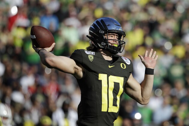 Oregon quarterback Justin Herbert passes against Wisconsin during first half of the Rose Bowl NCAA college football game Wednesday, Jan. 1, 2020, in Pasadena, Calif. (AP Photo/Marcio Jose Sanchez)