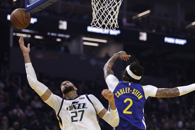 Utah Jazz center Rudy Gobert, left, reaches for a rebound past Golden State Warriors' Willie Cauley-Stein (2) in the first half of an NBA basketball game Wednesday, Jan. 22, 2020, in San Francisco. (AP Photo/Ben Margot)