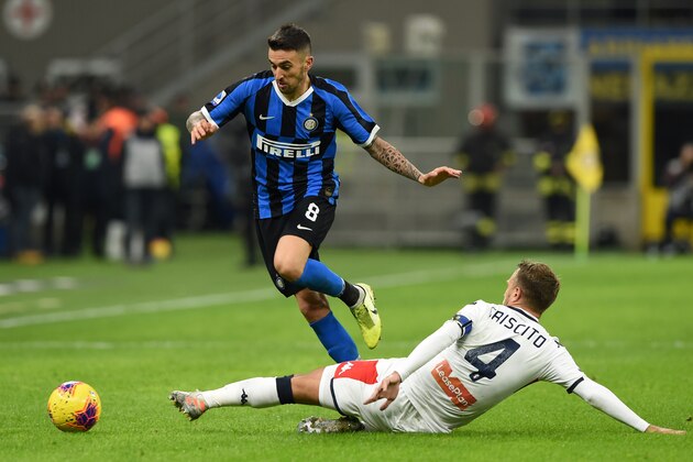 MILAN, ITALY - DECEMBER 21: Matias Vecino of FC Internazionale challenged by Domenico Criscito of Genoa CFC during the Serie A match between FC Internazionale and Genoa CFC at Stadio Giuseppe Meazza on December 21, 2019 in Milan, Italy. (Photo by Chris Ricco/Getty Images)