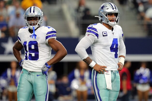 ARLINGTON, TEXAS - OCTOBER 06: Amari Cooper #19 of the Dallas Cowboys and Dak Prescott #4 of the Dallas Cowboys stand on the field in the first quarter against the Green Bay Packers at AT&T Stadium on October 06, 2019 in Arlington, Texas. (Photo by Richard Rodriguez/Getty Images)