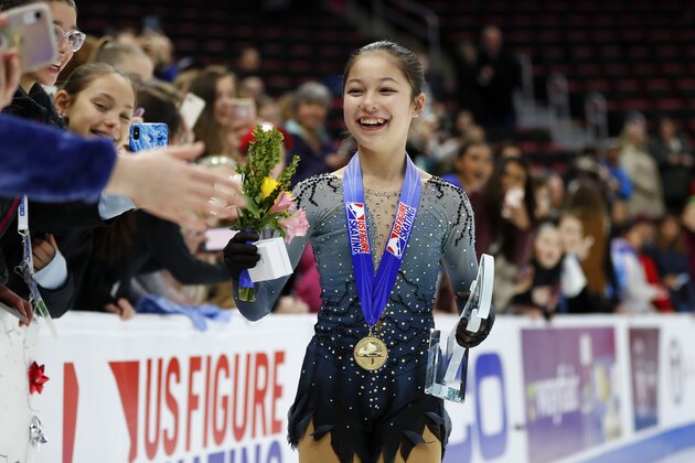 Alysa Liu greets fans while wearing her gold medal after winning the women's title at the U.S. Figure Skating Championships, Friday, Jan. 25, 2019, in Detroit. (AP Photo/Paul Sancya)