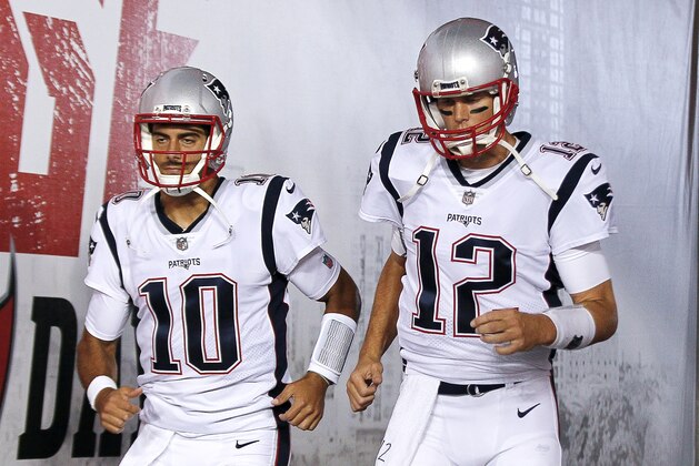 TAMPA, FL - OCTOBER 5: Quarterbacks Jimmy Garoppolo and Tom Brady #10 of the New England Patriots as they enter the field for pre-game warm-ups before the game against the Tampa Bay Buccaneers at Raymond James Stadium on October 5, 2017 in Tampa, Florida. The Patriots defeated the Buccaneers 19-14. (Photo by Don Juan Moore/Getty Images)