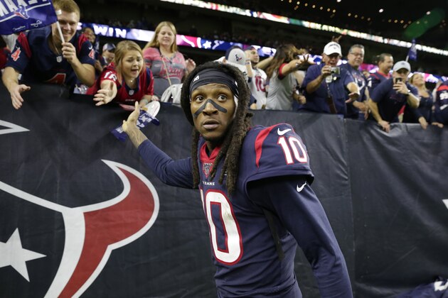 Houston Texans wide receiver DeAndre Hopkins celebrates with fans after an NFL wild-card playoff football game against the Buffalo Bills Saturday, Jan. 4, 2020, in Houston. The Texans won 22-19 in overtime. (AP Photo/Michael Wyke)