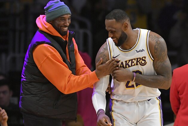LOS ANGELES, CA - DECEMBER 29: LeBron James #23 of the Los Angeles Lakers has a moment on the sideline with former Laker Kobe Bryant in the second half during a game against the Dallas Mavericks at Staples Center on December 29, 2019 in Los Angeles, California. NOTE TO USER: User expressly acknowledges and agrees that, by downloading and/or using this photograph, user is consenting to the terms and conditions of the Getty Images License Agreement. (Photo by John McCoy/Getty Images)