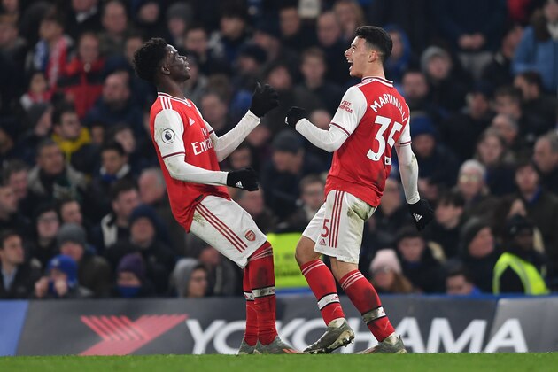 LONDON, ENGLAND - JANUARY 21: Gabriel Martinelli of Arsenal celebrates with teammate Bukayo Saka  after scoring his team's first goal during the Premier League match between Chelsea FC and Arsenal FC at Stamford Bridge on January 21, 2020 in London, United Kingdom. (Photo by Harriet Lander/Copa/Getty Images)