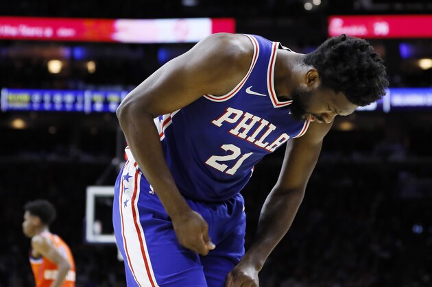 In this photo taken Jan. 6, 2020, Joel Embiid looks at his injured finger during an NBA basketball game against the Oklahoma City Thunder in Philadelphia. Embiid injured the radial collateral ligament in the ring finger in the first half Monday night against Oklahoma City. (AP Photo/Matt Slocum)