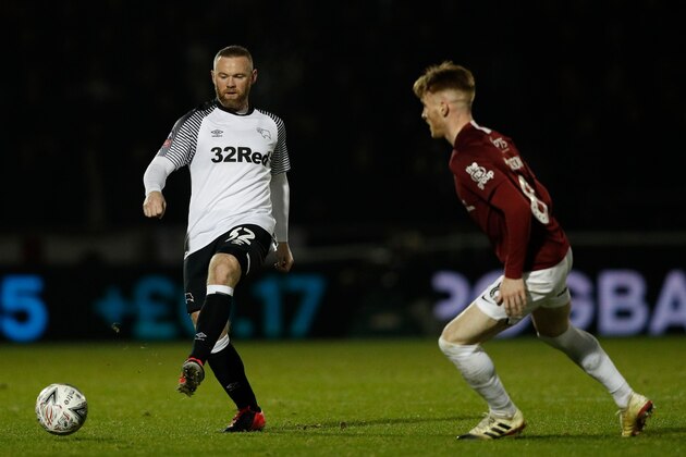 Derby County's English striker Wayne Rooney (L)  vies with Northampton Town's English midfielder Ryan Watson during the English FA Cup fourth round football match between between Northampton Town and Derby County at the Sixfields Stadium in Northampton, central England on January 24, 2020. (Photo by Adrian DENNIS / AFP) / RESTRICTED TO EDITORIAL USE. No use with unauthorized audio, video, data, fixture lists, club/league logos or 'live' services. Online in-match use limited to 120 images. An additional 40 images may be used in extra time. No video emulation. Social media in-match use limited to 120 images. An additional 40 images may be used in extra time. No use in betting publications, games or single club/league/player publications. /  (Photo by ADRIAN DENNIS/AFP via Getty Images)