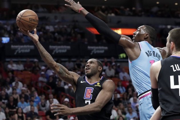 Los Angeles Clippers forward Kawhi Leonard, left, goes to the basket as Miami Heat forward Bam Adebayo defends during the first half of an NBA basketball game, Friday, Jan. 24, 2020, in Miami. (AP Photo/Lynne Sladky)