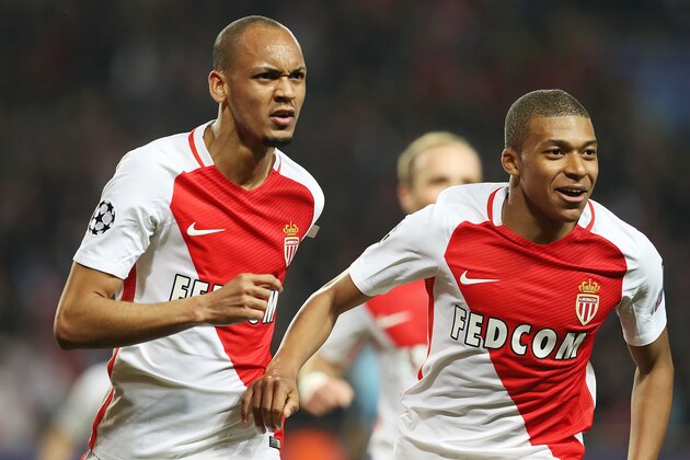 Monaco's Brazilian defender Fabinho (L) celebrates with Monaco's French forward Kylian Mbappe Lottin during the UEFA Champions League round of 16 football match between Monaco and Manchester City at the Stade Louis II in Monaco on March 15, 2017. / AFP PHOTO / Valery HACHE        (Photo credit should read VALERY HACHE/AFP via Getty Images)