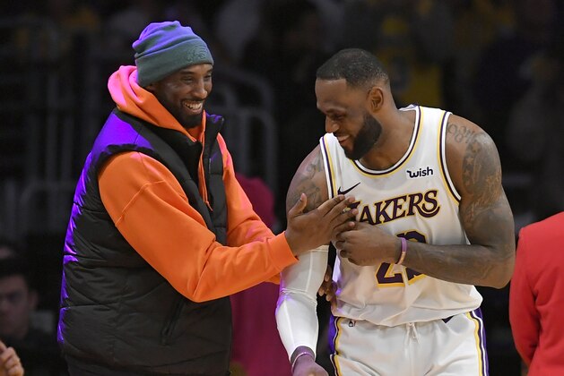 LOS ANGELES, CA - DECEMBER 29: LeBron James #23 of the Los Angeles Lakers has a moment on the sideline with former Laker Kobe Bryant in the second half during a game against the Dallas Mavericks at Staples Center on December 29, 2019 in Los Angeles, California. NOTE TO USER: User expressly acknowledges and agrees that, by downloading and/or using this photograph, user is consenting to the terms and conditions of the Getty Images License Agreement. (Photo by John McCoy/Getty Images)