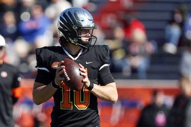 South quarterback Justin Herbert of Oregon (10) warms up before the start of the Senior Bowl college football game Saturday, Jan. 25, 2020, in Mobile, Ala. (AP Photo/Butch Dill)
