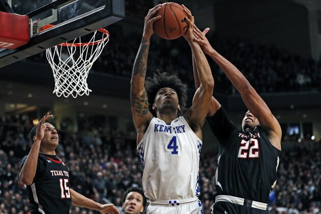 Kentucky's Nick Richards (4) and Texas Tech's TJ Holyfield (22) try to rebound the ball during overtime in an NCAA college basketball game Saturday, Jan. 25, 2020, in Lubbock, Texas. (AP Photo/Brad Tollefson)