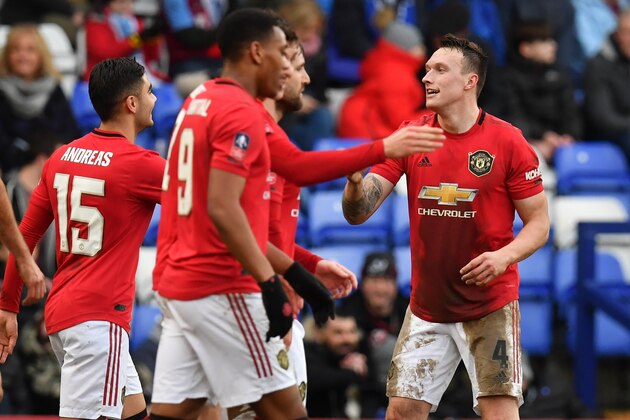 Manchester United's English defender Phil Jones (R) celebrates with teammates after scoring their fourth goal during the English FA Cup fourth round football match between Tranmere Rovers and Manchester United at Prenton Park in Birkenhead, north west England, on January 26, 2020. (Photo by Paul ELLIS / AFP) / RESTRICTED TO EDITORIAL USE. No use with unauthorized audio, video, data, fixture lists, club/league logos or 'live' services. Online in-match use limited to 120 images. An additional 40 images may be used in extra time. No video emulation. Social media in-match use limited to 120 images. An additional 40 images may be used in extra time. No use in betting publications, games or single club/league/player publications. /  (Photo by PAUL ELLIS/AFP via Getty Images)