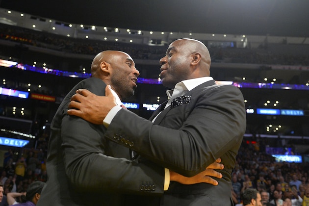 LOS ANGELES, CA - OCTOBER 25:  Former Los Angeles Lakers Kobe Bryant, left and Earvin Magic Johnson, president of basketball operations of the Lakers talk during the game between the Los Angeles Lakers and the Denver Nuggets on October 25, 2018 at STAPLES Center in Los Angeles, California. NOTE TO USER: User expressly acknowledges and agrees that, by downloading and or using this photograph, User is consenting to the terms and conditions of the Getty Images License Agreement.  (Photo by Robert Laberge/Getty Images)