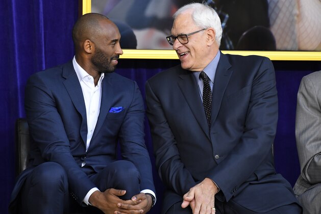 Kobe Bryant, left, and Phil Jackson chat at the unveiling of Shaquille O'Neal's statue in front of Staples Center, Friday, March 24, 2017, in Los Angeles. (AP Photo/Mark J. Terrill)