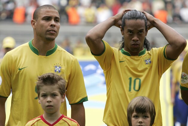 Brazilian stars Ronaldo, left, and Ronaldinho wait for the kick off of the World Cup, Round of 16 soccer match between Brazil and Ghana, at the Dortmund stadium, Germany, Tuesday, June 27, 2006. (AP Photo/Mark J. Terrill) **MOBILE/PDA USAGE OUT**