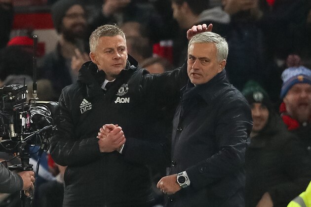 MANCHESTER, ENGLAND - DECEMBER 04: Ole Gunnar Solskjaer the head coach / maanager of Manchester United consoles Jose Mourino the head coach / manager of Tottenham Hotspur walks off after the Premier League match between Manchester United and Tottenham Hotspur at Old Trafford on December 4, 2019 in Manchester, United Kingdom. (Photo by Matthew Ashton - AMA/Getty Images)