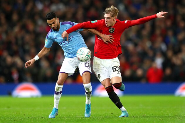 MANCHESTER, ENGLAND - JANUARY 07: Riyad Mahrez of Manchester City is challenged by Brandon Williams of Manchester United during the Carabao Cup Semi Final match between Manchester United and Manchester City at Old Trafford on January 07, 2020 in Manchester, England. (Photo by Michael Steele/Getty Images)