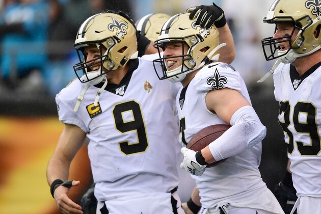 CHARLOTTE, NORTH CAROLINA - DECEMBER 29: Drew Brees #9 and Taysom Hill #7 of the New Orleans Saints celebrate a touchdown pass during the third quarter during their game against the Carolina Panthers at Bank of America Stadium on December 29, 2019 in Charlotte, North Carolina. (Photo by Jacob Kupferman/Getty Images)