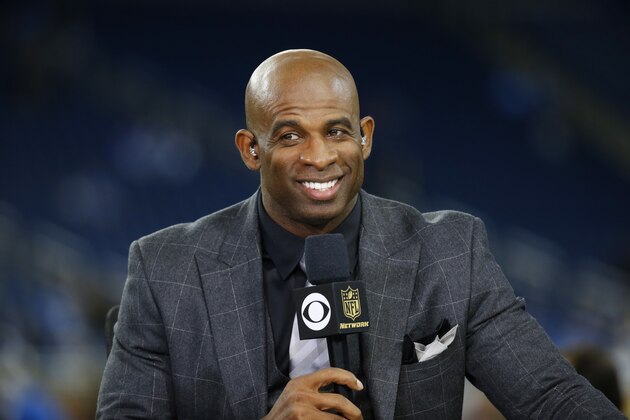Thursday Night Football host Deion Sanders talks on the Ford Field set during pregame of an NFL football game between the Detroit Lions and the Green Bay Packers, Thursday, Dec. 3, 2015, in Detroit. (AP Photo/Paul Sancya)