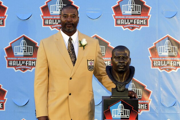 Former NFL player Chris Doleman poses with a bust of himself during an induction ceremony at the Pro Football Hall of Fame, Saturday, Aug. 4, 2012, in Canton, Ohio . (AP Photo/Gene J. Puskar)