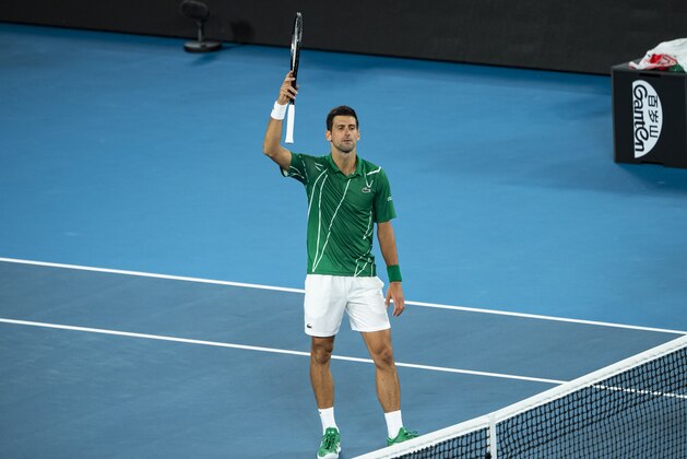 MELBOURNE, AUSTRALIA - JANUARY 28: Novak Djokovic of Serbia celebrates his victory in his quarter final match against Milos Raonic of Canada on day nine of the 2020 Australian Open at Melbourne Park on January 28, 2020 in Melbourne, Australia. (Photo by TPN/Getty Images)