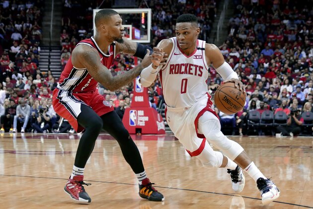 Houston Rockets guard Russell Westbrook (0) drives around Portland Trail Blazers guard Damian Lillard, left, during the second half of an NBA basketball game Wednesday, Jan. 15, 2020, in Houston. (AP Photo/Michael Wyke)