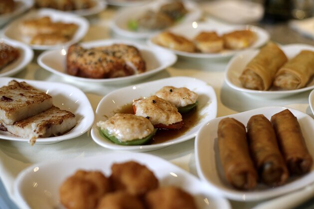 In this photo taken Saturday, July 5, 2014, a variety of dishes are displayed on a dim sum food cart at Bo Lings Chinese restaurant in Kansas City, Mo. In a city known for barbecue, the eatery offers an alternative to ribs by offering dim sum on weekends. (AP Photo/Charlie Riedel)