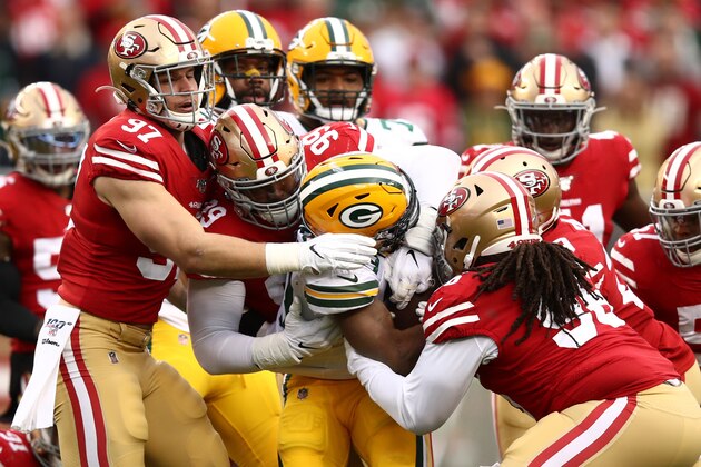 SANTA CLARA, CALIFORNIA - JANUARY 19: Aaron Jones #33 of the Green Bay Packers is tackled by a group of San Francisco 49ers in the first half during the NFC Championship game at Levi's Stadium on January 19, 2020 in Santa Clara, California. (Photo by Ezra Shaw/Getty Images)