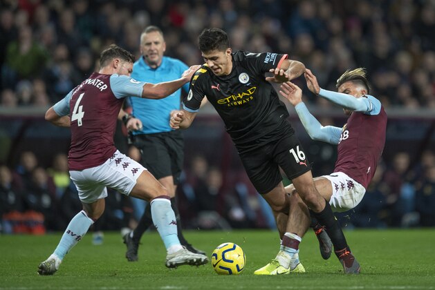 BIRMINGHAM, ENGLAND - JANUARY 12: Rodrigo of Manchester City in action with Jack Grealish and Daniel Drinkwater of Aston Villa during the Premier League match between Aston Villa and Manchester City at Villa Park on January 12, 2020 in Birmingham, United Kingdom. (Photo by Visionhaus)