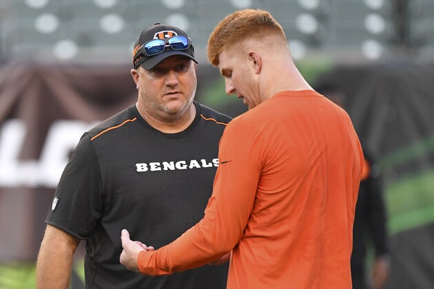 Cincinnati Bengals quarterback Andy Dalton, right, and quarterbacks coach Alex Van Pelt, left, meet on the field during practice before an NFL football game against the Baltimore Ravens, Thursday, Sept. 13, 2018, in Cincinnati. (AP Photo/Bryan Woolston)