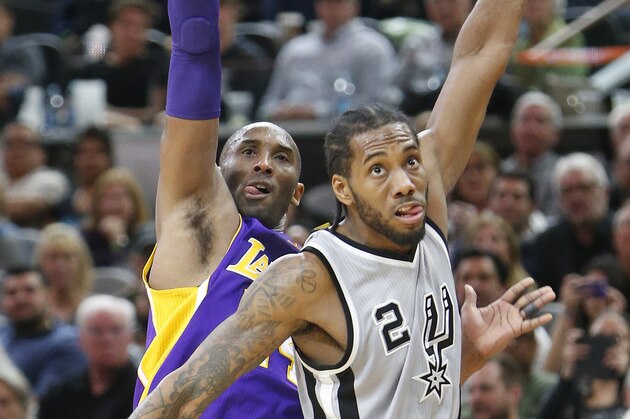 SAN ANTONIO,TX - FEBRUARY 6:  Kobe Bryant #24 of the Los Angeles Lakers and Kawhi Leonard #2 of the San Antonio Spurs follow Bryant three point shot at AT&T Center on February 6, 2016 in San Antonio, Texas.  NOTE TO USER: User expressly acknowledges and agrees that , by downloading and or using this photograph, User is consenting to the terms and conditions of the Getty Images License Agreement. (Photo by Ronald Cortes/Getty Images)