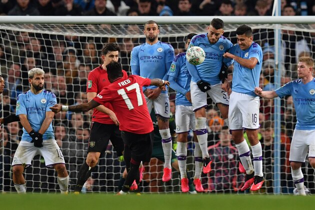 Manchester United's Brazilian midfielder Fred drives the ball into the wall as he takes a free kick during the English League Cup semi-final second leg football match between Manchester City and Manchester United at the Etihad Stadium in Manchester, north west England, on January 29, 2020. (Photo by Paul ELLIS / AFP) / RESTRICTED TO EDITORIAL USE. No use with unauthorized audio, video, data, fixture lists, club/league logos or 'live' services. Online in-match use limited to 120 images. An additional 40 images may be used in extra time. No video emulation. Social media in-match use limited to 120 images. An additional 40 images may be used in extra time. No use in betting publications, games or single club/league/player publications. /  (Photo by PAUL ELLIS/AFP via Getty Images)
